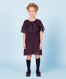  navy dress with red polka details with layered sleeves and a bow on the neck