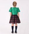 Girls' plaid and green bow outfit for festive occasions – A charming combination of a traditional plaid skirt and eye-catching green metallic bow top, perfect for making a stylish statement