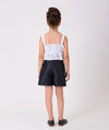 ecru ruffled blouse and navy shorts for summer