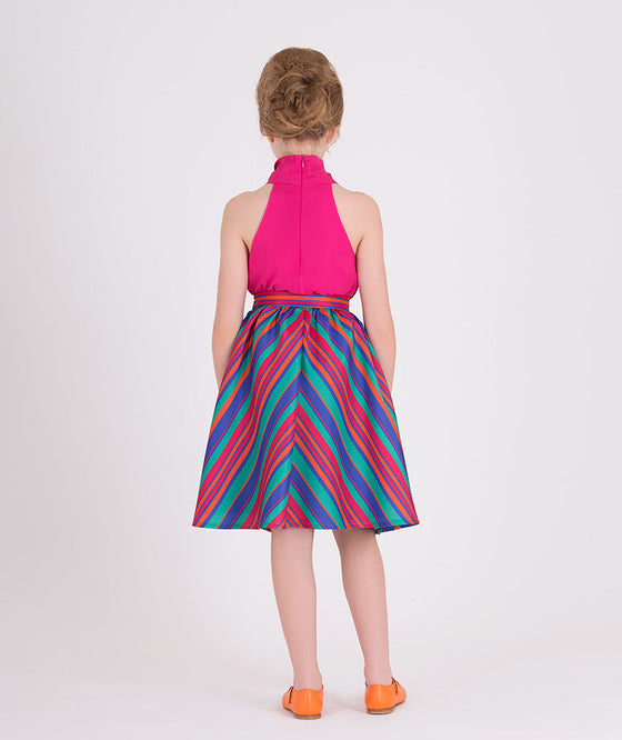 fuschia top and a multicolor striped skirt